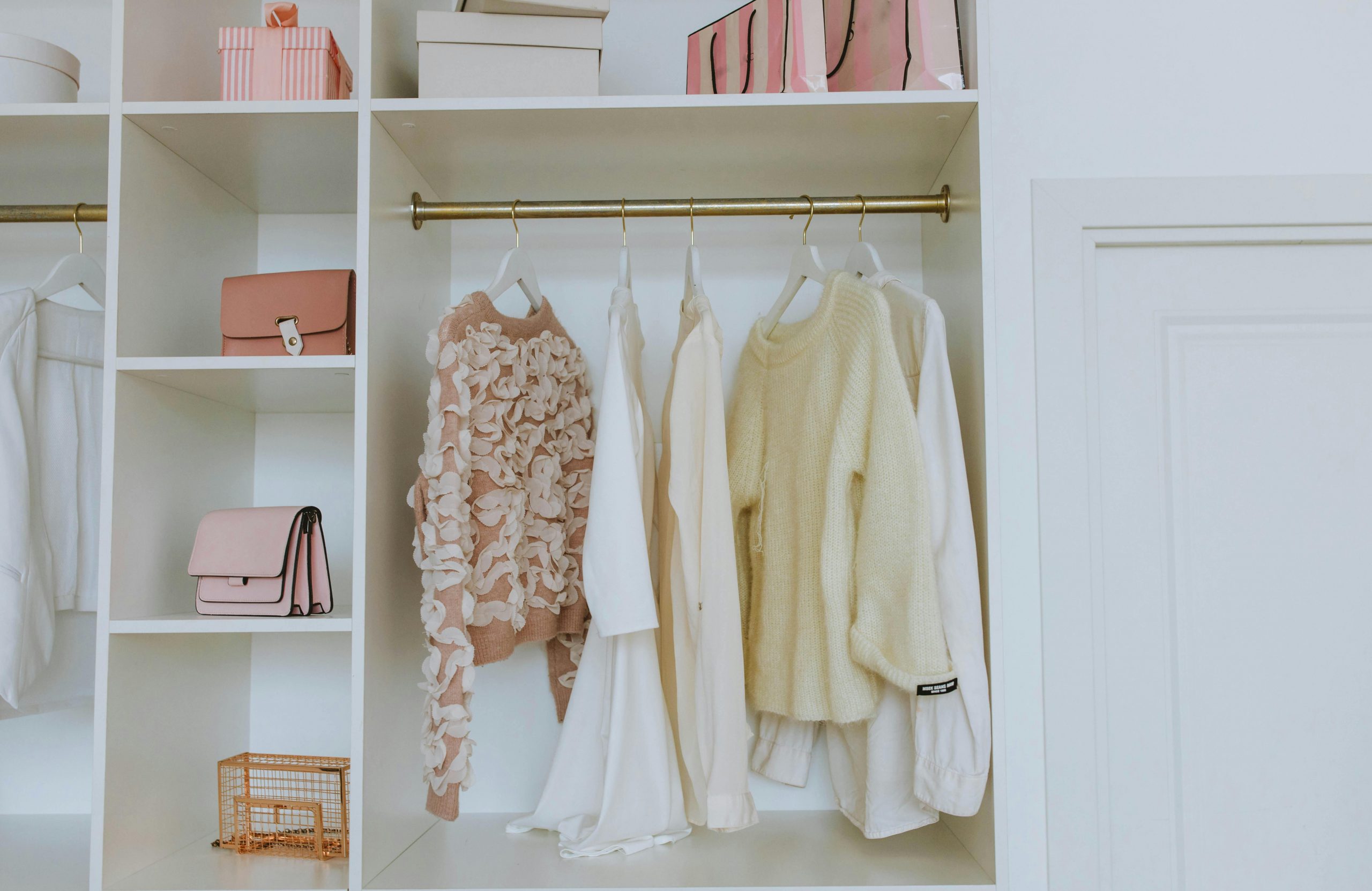 clothes and bags in a big, white closet