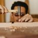 man hammering a nail into wood